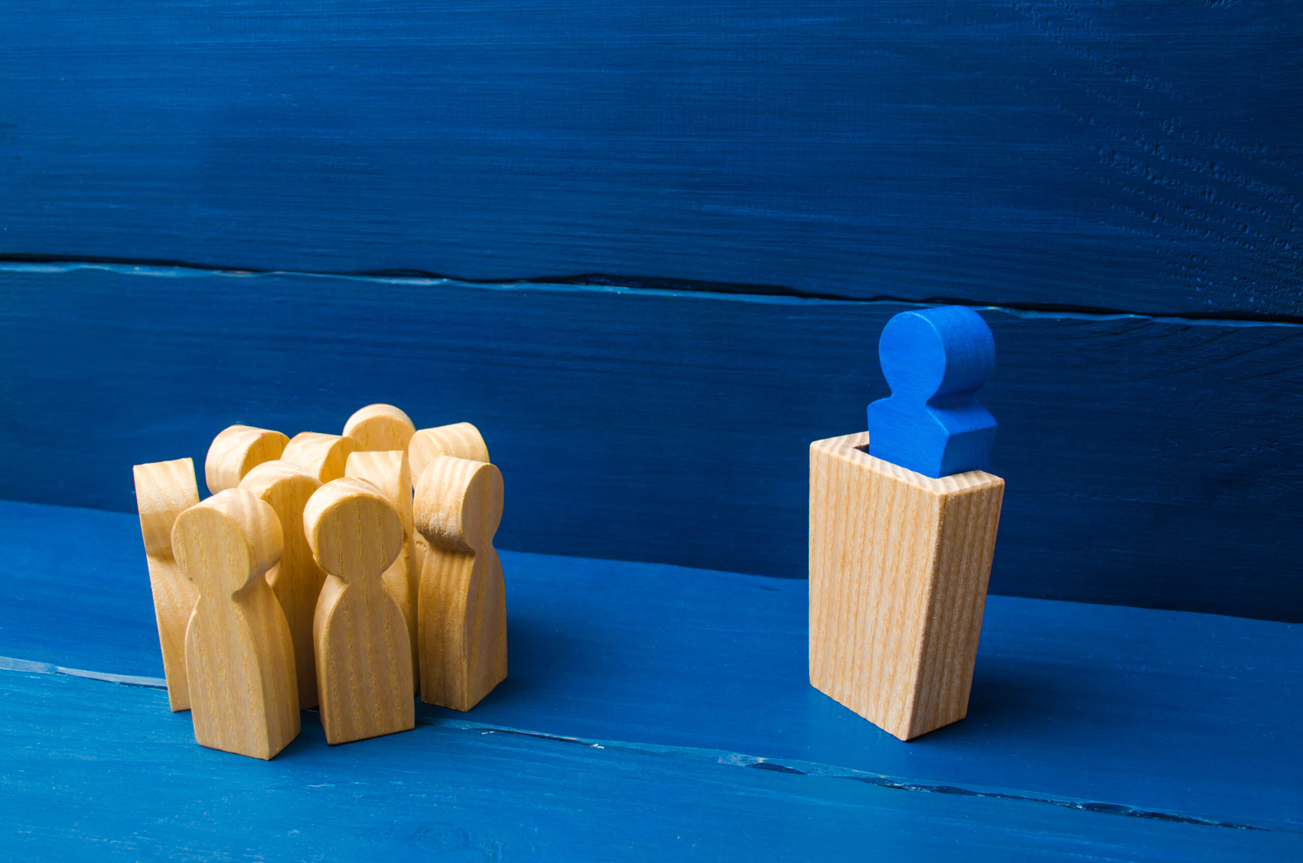 Business concept of leader and leadership qualities, crowd management, political debate and elections. Business management. The leader from the rostrum speaks a speech addressing a crowd of people.